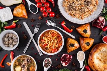 The concept of Eastern asian festive cuisine. Assorted Uzbek food set, pilaf, samsa, lagman, manti, shurpa restaurant concept Eastern arabic new year and Christmas dish from lamb served cookware.