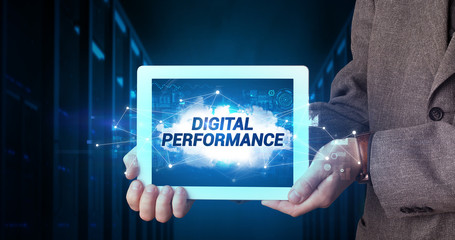 Young business person working on tablet and shows the inscription: DIGITAL PERFORMANCE