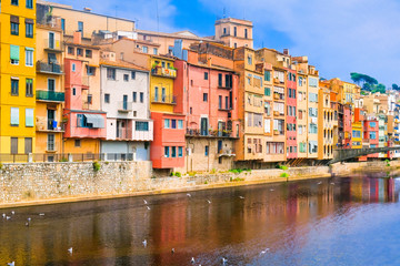 View of embankment of Onyar river with colorful medieval houses. Girona, Catalonia, Spain.