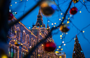 Festive street decor in winter holidays. Shining garland lights. Magical atmosphere. Blurred background city street with Christmas illuminations.