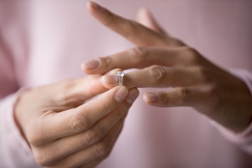 Close up of woman removing ring filing for divorce