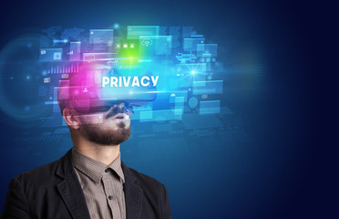 Businessman looking through Virtual Reality glasses with PRIVACY inscription, innovative security concept