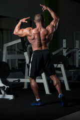 Fototapeta na wymiar Mature Bodybuilder Flexing Muscles