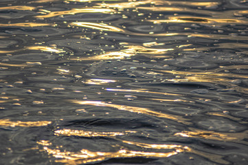 Waves at sunset on the river water
