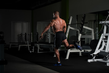 Naklejka na ściany i meble Muscular Mature Man Flexing Muscles In Gym