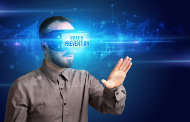 Businessman looking through Virtual Reality glasses with FRAUD PREVENTION inscription, cyber security concept