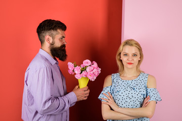 Love, relationship, dating. Man giving bouquet of roses to his girlfriend. Couple in love with bouquet of flowers. Handsome bearded man gives bouquet of flowers to woman. Beautiful romantic couple.