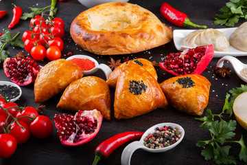 The concept of Eastern asian festive cuisine. Assorted Uzbek food set, pilaf, samsa, lagman, manti, shurpa restaurant concept Eastern arabic new year and Christmas dish from lamb served cookware.
