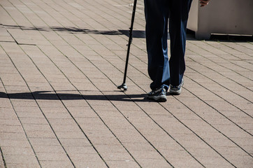 Man walking with walking sticks in hand