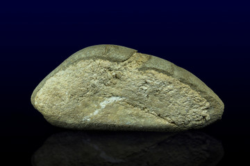 Unusual decorative stone like bread on the dark background - close up