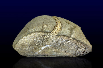 Unusual decorative stone like bread on the dark background - close up