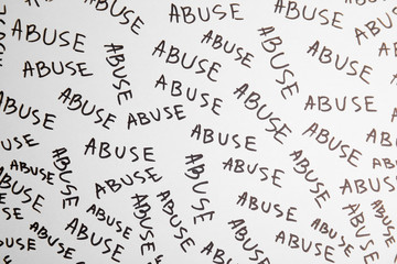 Sheet of paper with words ABUSE, top view. Domestic violence awareness