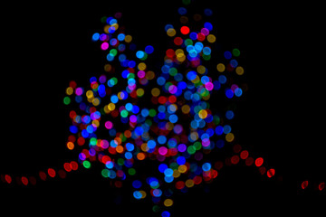Colorful group of holiday lights on dark background of night.