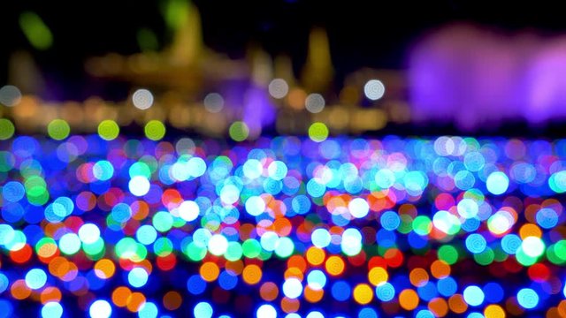 Abstract Light Bokeh Background.blur lights from Light bulbs sparkle circle lit celebrations display Christmas wallpaper decorations concept.Light effect many color move and blur in carnival festival.