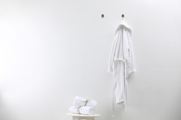 Soft comfortable bathrobe and towels indoors, space for text