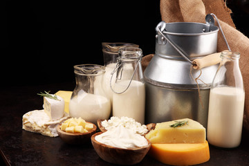 Different  healthy dairy products on rustic background with milk, cheese, butter and cottage