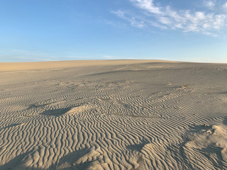 White sand dune and blue sky