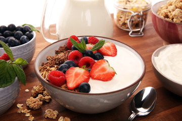 Tasty homemade granola served on table. Healthy breakfast with a bowl of oatmeal with banana, blueberries, strawberries and healthy food for Breakfast