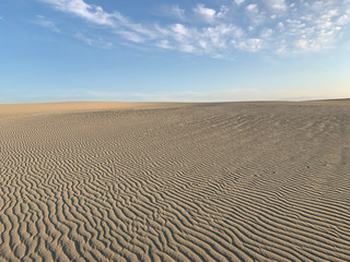White sand dune and blue sky