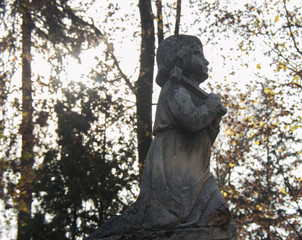 Monument and candles in the cemetery. All Saints Day in Poland.