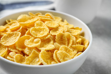 Tasty corn flakes on light grey table, closeup