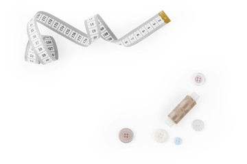 Set from sewing Accessories (a centimetric measuring tape, a set of buttons, color threads) with empty space for text isolated on the white background.