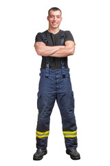 Young smiling firefighter with folded arms wearing black t-shirt and fireproof pants with suspenders. isolated on a white background
