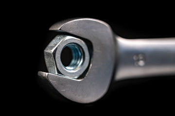 Nickel-plated wrench and nut. Workshop accessories needed for mounting mechanical parts.