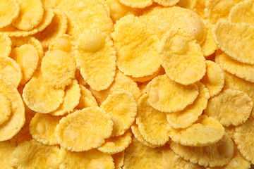Tasty crispy corn flakes as background, top view