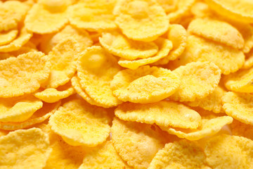 Tasty crispy corn flakes as background, closeup