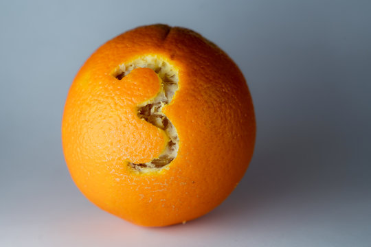 Nummer 3 einer Schriftart in die Schale einer Orange geritzt