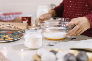 Close-up of womans hand holding bowl with mixture