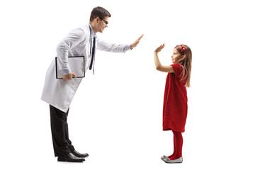 Male doctor giving a high-five to a little girl