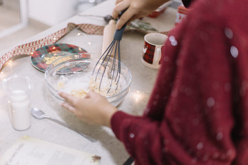 Woman preparing cookies dough on kitchen table