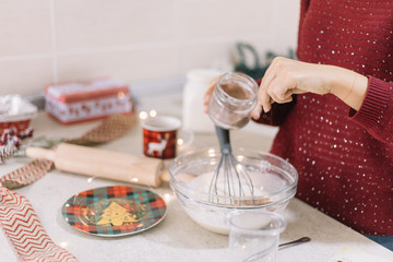 Females hand pouring cinnamon to a mixture