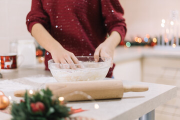 Girls hands kneading dough for Christmas cookies