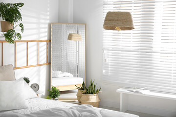 Modern bedroom interior with stylish large mirror