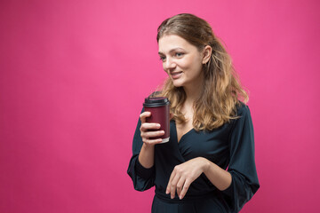 Glamor woman with a drink of coffee on a pink background