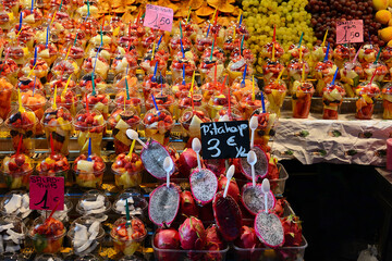 Ready to eat fruit salad in plastic container at La Boqueria Market in Las Rambas, Barcelona, Spain)