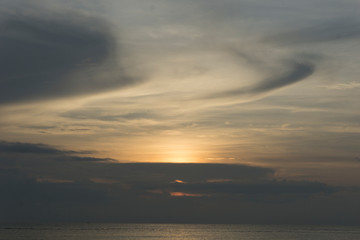 Beautiful dawn, morning sun rises by the sea. Scenic beach, coastline, rocks, cloudscape and skyline photography. Sunrise during the early hours of a summer morning by the beach. Sunset by the beach.