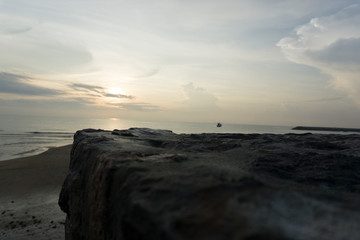 Beautiful dawn, morning sun rises by the sea. Scenic beach, coastline, rocks, cloudscape and skyline photography. Sunrise during the early hours of a summer morning by the beach. Sunset by the beach.