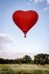 Fototapeta premium Heart shaped balloon soars in the sky