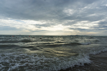 Fototapeta premium Beautiful dawn, morning sun rises by the sea. Scenic beach, coastline, rocks, cloudscape and skyline photography. Sunrise during the early hours of a summer morning by the beach. Sunset by the beach.