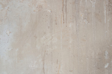 generic background of a marbled concrete wall or floor surface stained of age and usage oved a long period of time in light beige colors