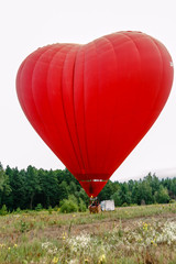 Fototapeta premium Heart shaped balloon soars in the sky