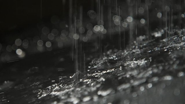 Fairylike spots of rainy water filling cave land with strange dots in slo-mo