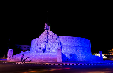 Tourist taking photos of the Monument to the Fatherland at night, Yucatan, Mexico. Patria Monument in Paseo de Montejo. Merida