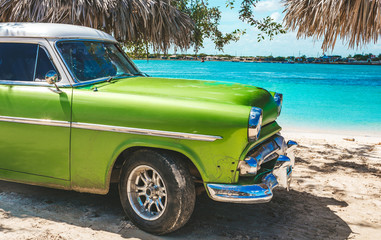 Playa La Herradura, Cuba - October 27, 2019: American classic car on the beach Playa La Herradura, Province Las Tunas, Cuba