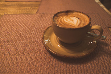 Cappuccino coffee Cup on the table, vintage style