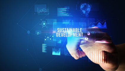 Hand touching SUSTAINABLE DEVELOPMENT inscription, new business technology concept